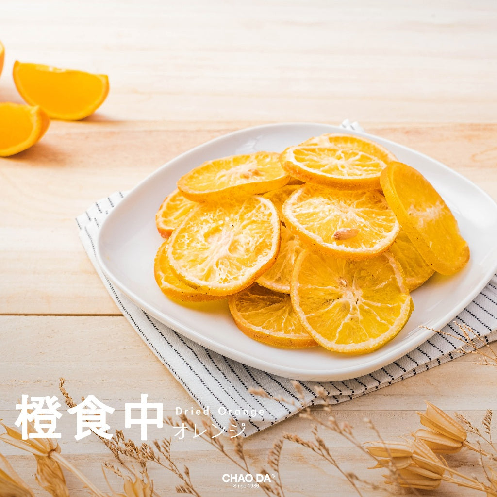 Dried orange slices on a white plate with a wooden background