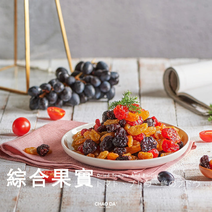 Dried fruits on a plate with grapes and tomatoes on a wooden table