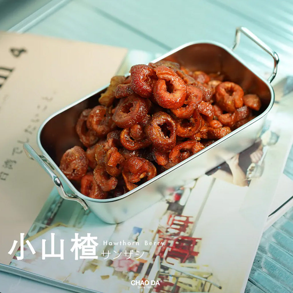 Metallic container filled with dried fruit on a magazine