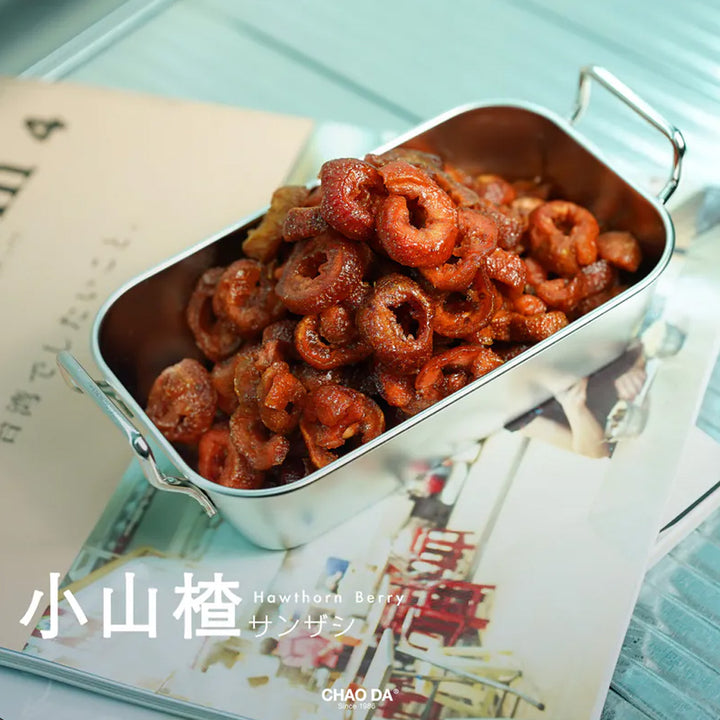 Metallic container filled with dried fruit on a magazine