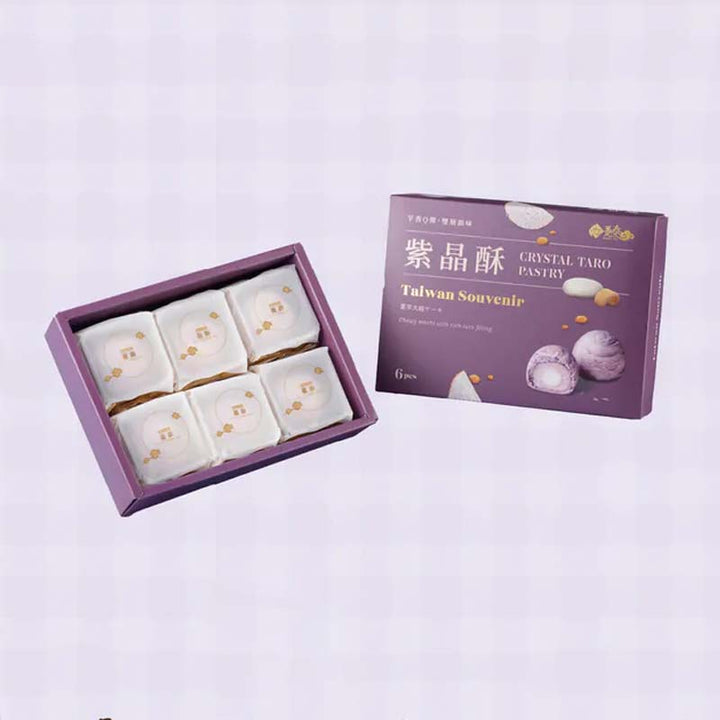 Box of white pastries with a purple box labeled 'Crystal Taro Pastry' on a light purple background