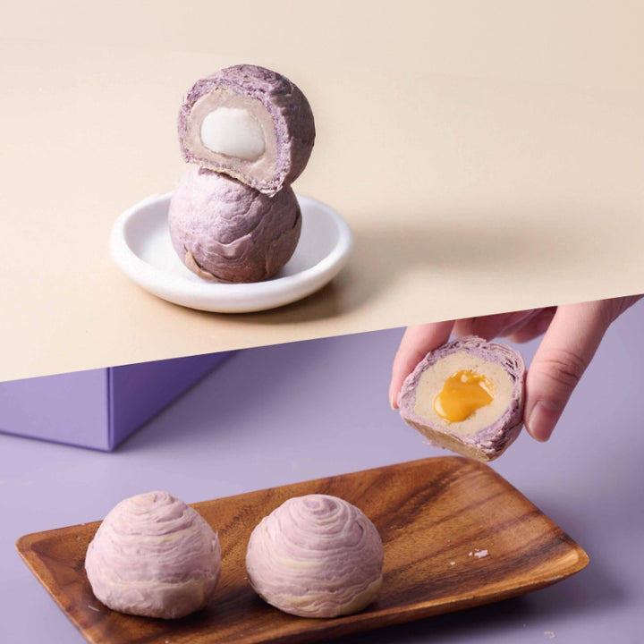 Purple pastries with a soft yellow center on a wooden plate and beige surface.