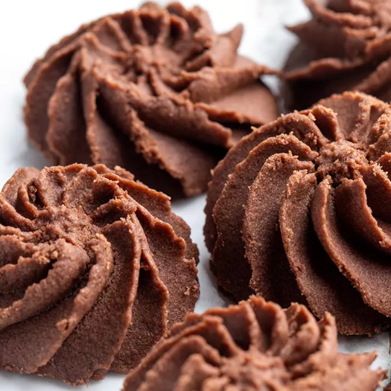 Close-up of chocolate cookies with a swirl pattern on a white background