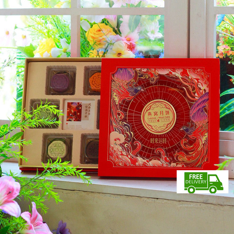Red and gold gift box with floral decorations on a windowsill
