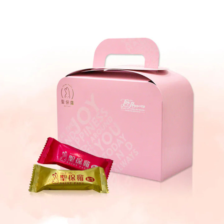 Pink gift box with two candy packages on a light pink background