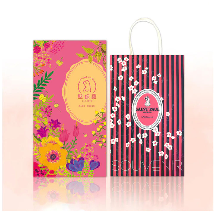 Two colorful gift bags with floral designs and 'Saint Paul' branding on a pink background.
